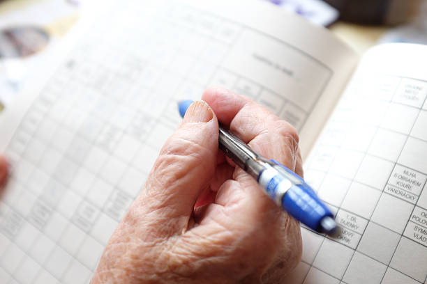 istock Elderly woman solving a crossword 2248071001