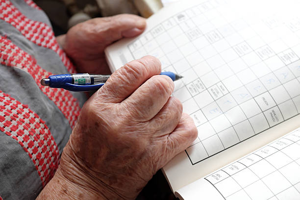 istock Elderly woman solving a crossword 2248071022