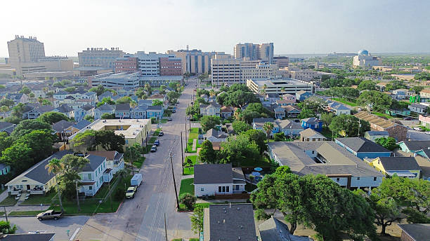 istock Vibrant residential grid gives way to dense medical complex with modern architecture, flat rooftops, structured parking, highlighting urban layering and institutional sprawl in Galveston, Texas 2248071074