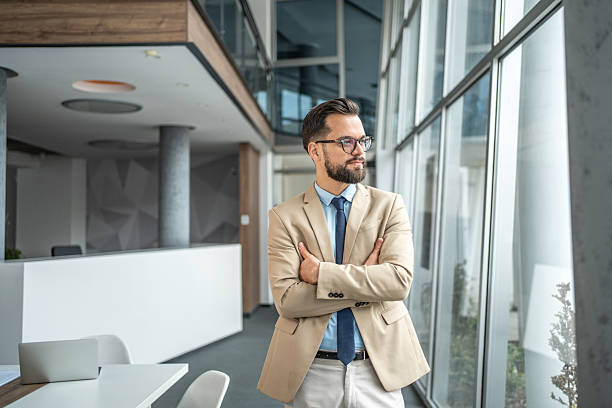 istock Confident businessman standing in modern office looking contemplating 2248072347