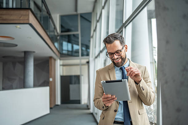 istock Happy businessman using digital tablet in modern office 2248072566
