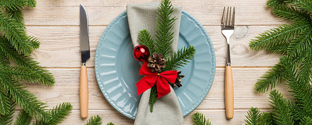 istock Christmas table place setting with christmas decor and plates, kine, fork and spoon. Christmas holiday background. Top view 2248073720
