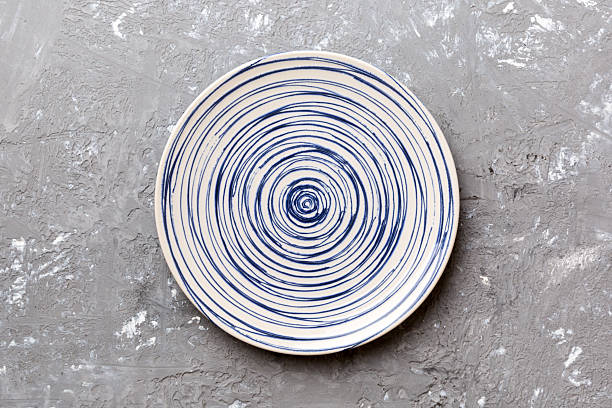 istock Top view of empty colorful plate on cement background. Empty space for your design 2248073766