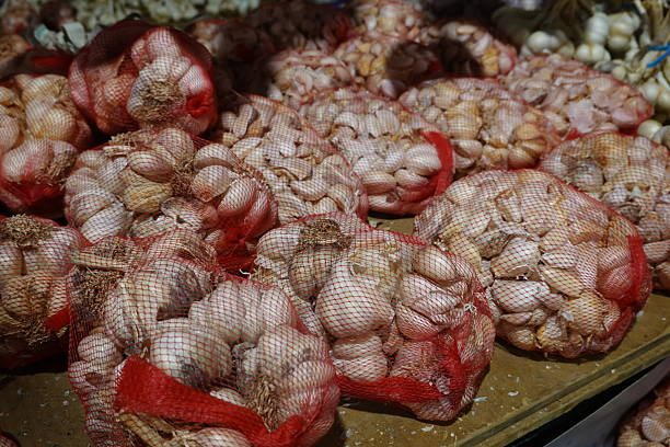 istock Garlic bulbs in mesh bags for sale 2248075378