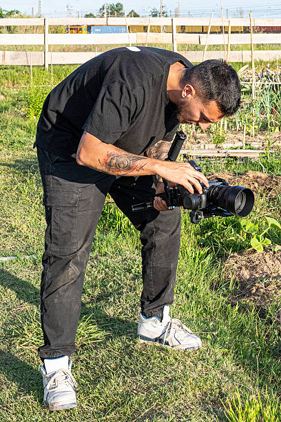 istock Videographer filming vegetables growing in garden with gimbal and mirrorless camera 2248075536