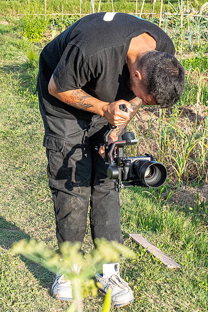 istock Videographer filming vegetables growing in garden with gimbal and mirrorless camera 2248075539