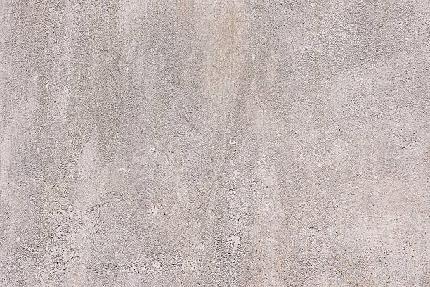 istock Textured gray concrete wall surface background with rough porous pattern 2248077057