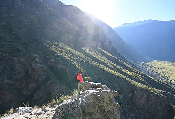 istock Female tourist with a camera enjoys a mountain view 2248077773