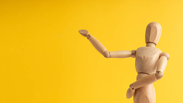 istock Wooden mannequin pointing upwards with one arm folded 2248078873