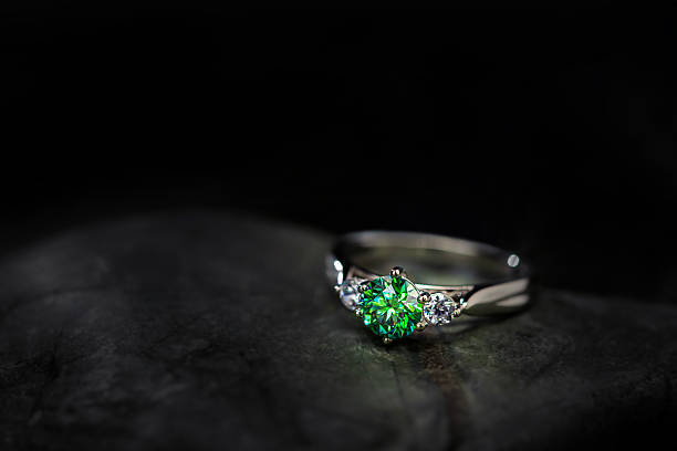 A gold ring on a stone. Black background with copy space