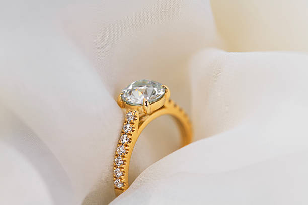 istock A gold and diamond ring is displayed on a white cloth 2248081300