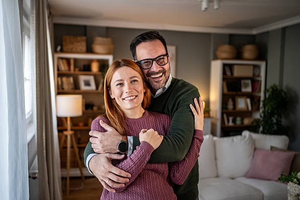 istock Happy couple hugging at home smiling to camera 2248081530