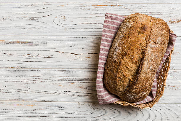 istock Freshly baked bread on basket against natural background. top view bread copy space 2248082449