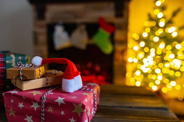 istock Cozy Christmas Interior with Fireplace, Gift Boxes, and Decorated Tree with Warm Lights 2248083716