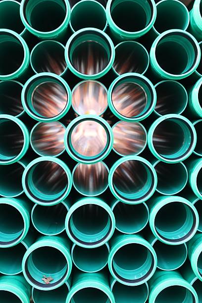 istock Abstract view of green plastic pipes stacked together 2248085842