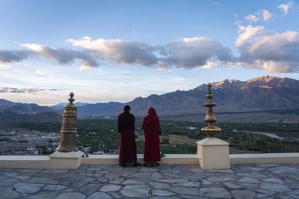 Thiksey, India - September 12, 2024: Two monks blow horns as part of the daily morning ceremony at Thiksey monastery.