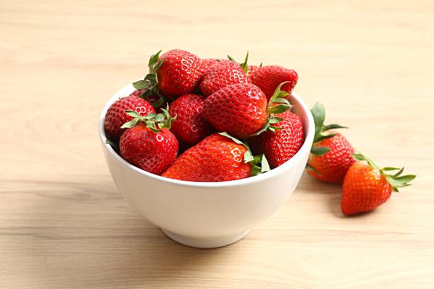 istock Delicious fresh red strawberries in a bowl on a light background 2248086928