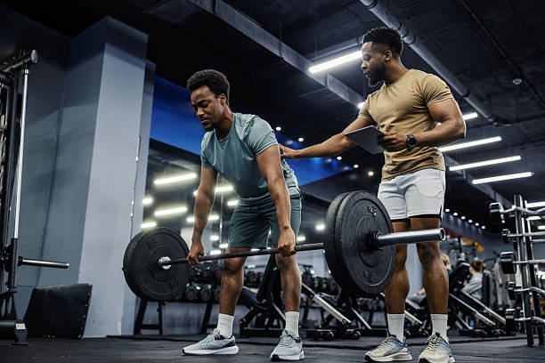 istock Personal trainer coaching man doing deadlift in gym 2248093315