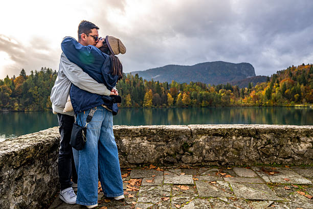 Couple sharing romantic moment during autumn trip in Bled Slovenia