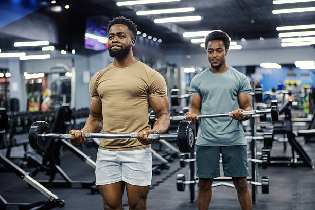 istock Men lifting barbells doing bicep curls at gym 2248093507