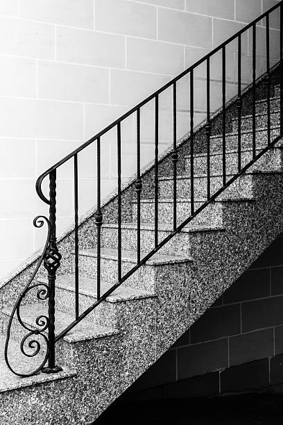 istock Black and White Staircase With Iron Railing Along Granite Steps, Architectural Detail and Shadows 2248094015