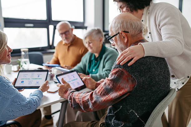 istock Group of senior people learning digital skills with tutor help. 2248095142