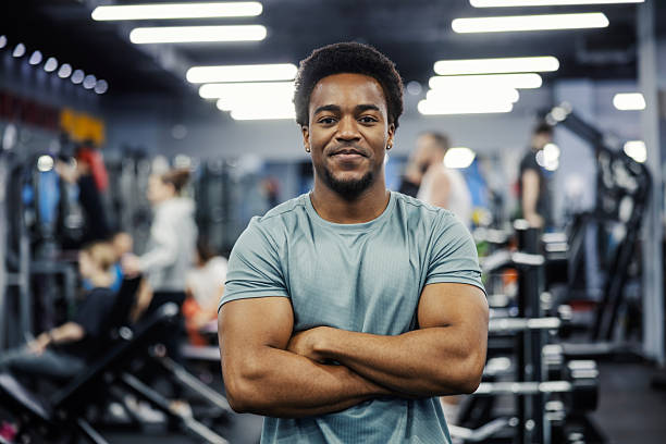istock Confident man crossing arms standing in gym 2248095189