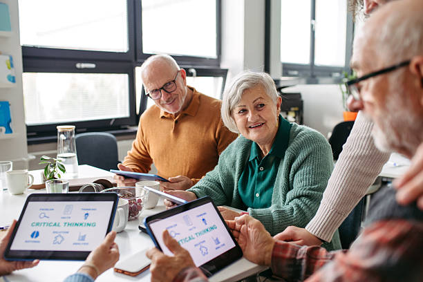 istock Group of senior people learning digital skills with tutor help. 2248095248