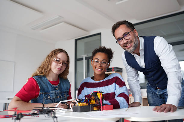 istock High school students working on robotics project with their teacher. 2248095543