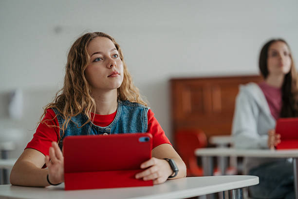 istock Teen student listening attentively during class with a digital tablet. 2248096264
