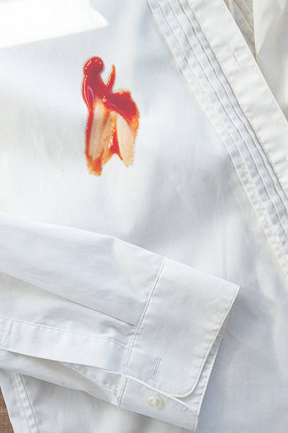 istock White shirt stained with ketchup, no people, close-up , selective focus, 2248098136
