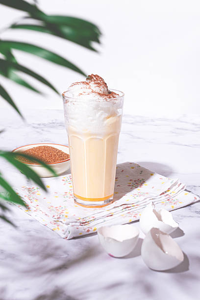 istock eggnog drink, egg yolk, in a glass, with cream and cinnamon, sunlight, 2248098283