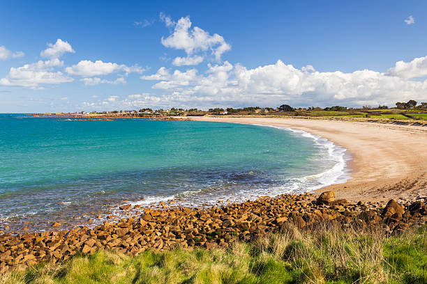 istock Fermanville beach showing clear turquoise water and sandy shore 2248101176