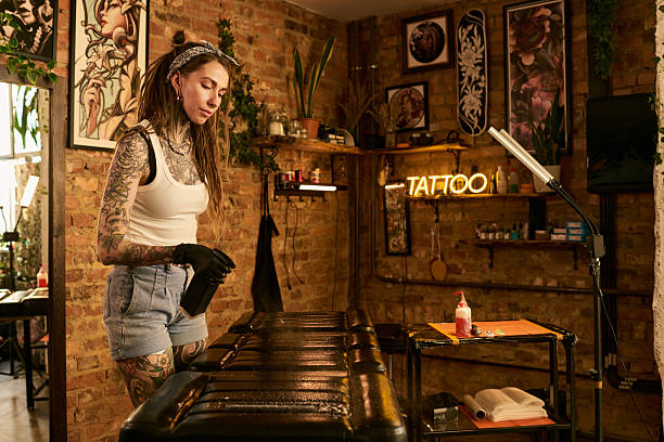 istock Young Woman Tattoo Artist Preparing Workstation in Studio 2248101446