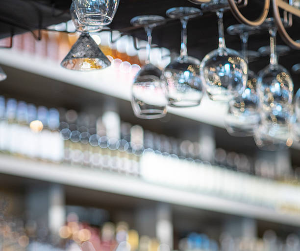 istock Elegant upside-down wine glasses hang from a sleek overhead rack in a modern bar or upscale restaurant. 2248101886