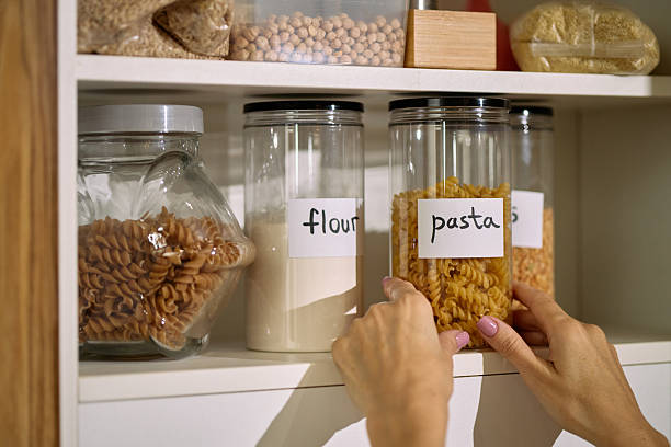 istock Woman Organizing Pasta and Flour in Kitchen Pantry Shelf 2248102207