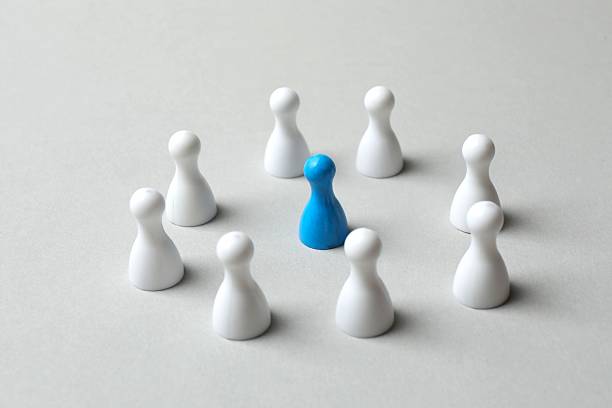 istock Group of pawns on gray table. Concept of unity 2248102554