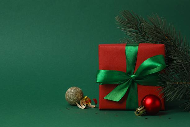 istock Beautiful gift box tied with green bow on color background 2248102586