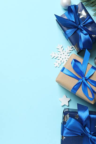 istock Vertical festive scene with wrapped gift boxes on blue background. Christmas concept 2248102615
