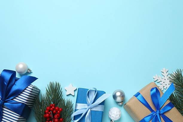 istock Festive composition with gift boxes  and ornaments on blue background, top view 2248102623