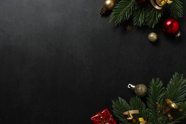 istock Christmas ornaments and pine branches on black background. Flat lay, top view 2248103077