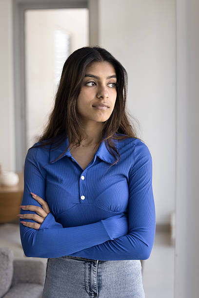 istock Pensive young Indian woman posing at home with hands folded 2248104095