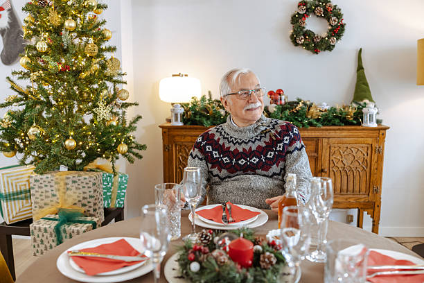 istock Senior man at a table during Christmas time 2248104951