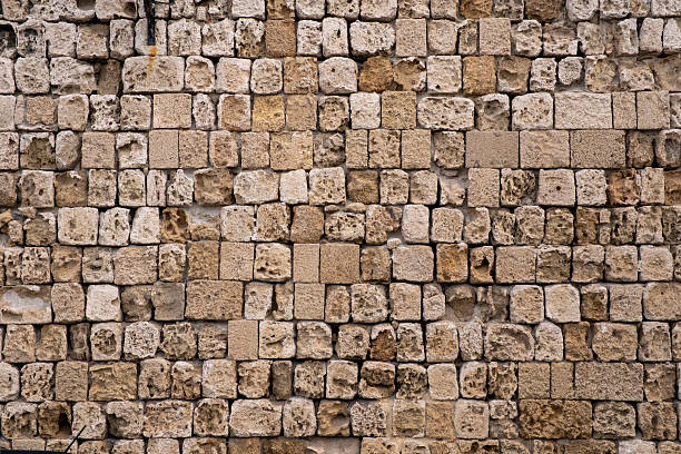 Detail of old stone wall showcasing rustic texture and earthy tones, perfect for backgrounds