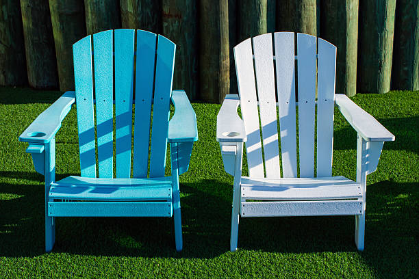 istock four outdoors Adirondack chairs colors white and aqua blue on green turf 2248109623
