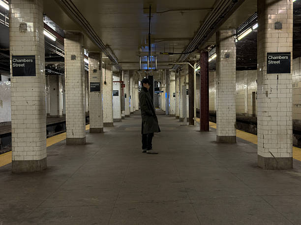 Person waiting at dilapidated subway station in New York City