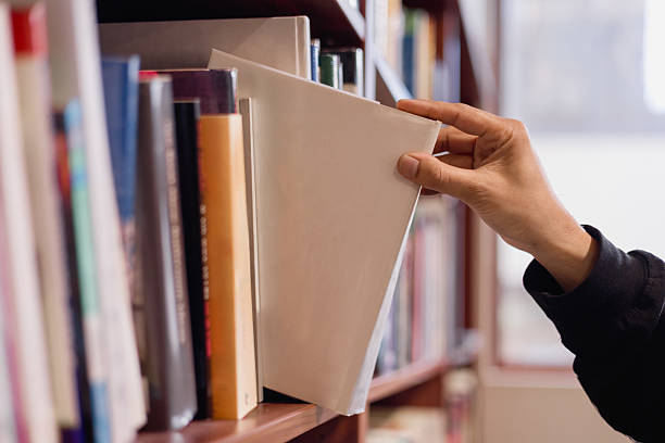 istock hand taking binder from bookshelf in office library. Concept of business organization, document management, archive, education, and knowledge storage. 2248123389