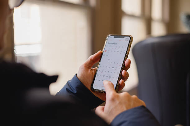 istock hand using smartphone with calendar app on screen. Concept of time management, planning, scheduling, productivity, digital organizer, business reminder modern lifestyle efficiency. 2248123417