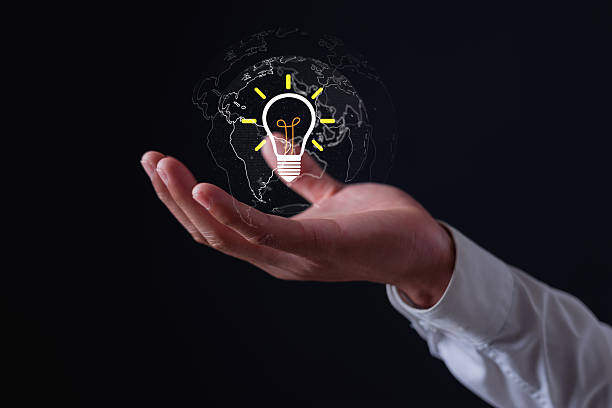 istock Businessman holding glowing light bulb hologram with world map, symbolizing global innovation, creativity, new ideas, technology solutions business inspiration for success. 2248123560