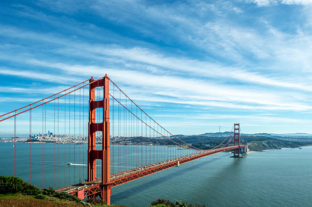 Golden Gate Bridge and San Francisco in the background under a cloudy sky.Taken at Marin Headlands, California, USA.